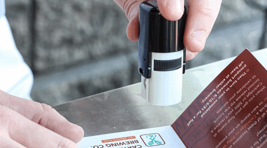 A Sip Trip passport being stamped by a bartender.